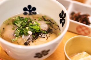 white and blue ceramic bowl with soup