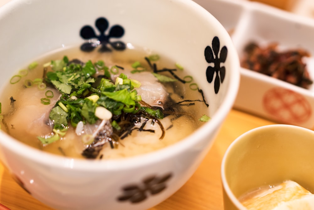 white and blue ceramic bowl with soup