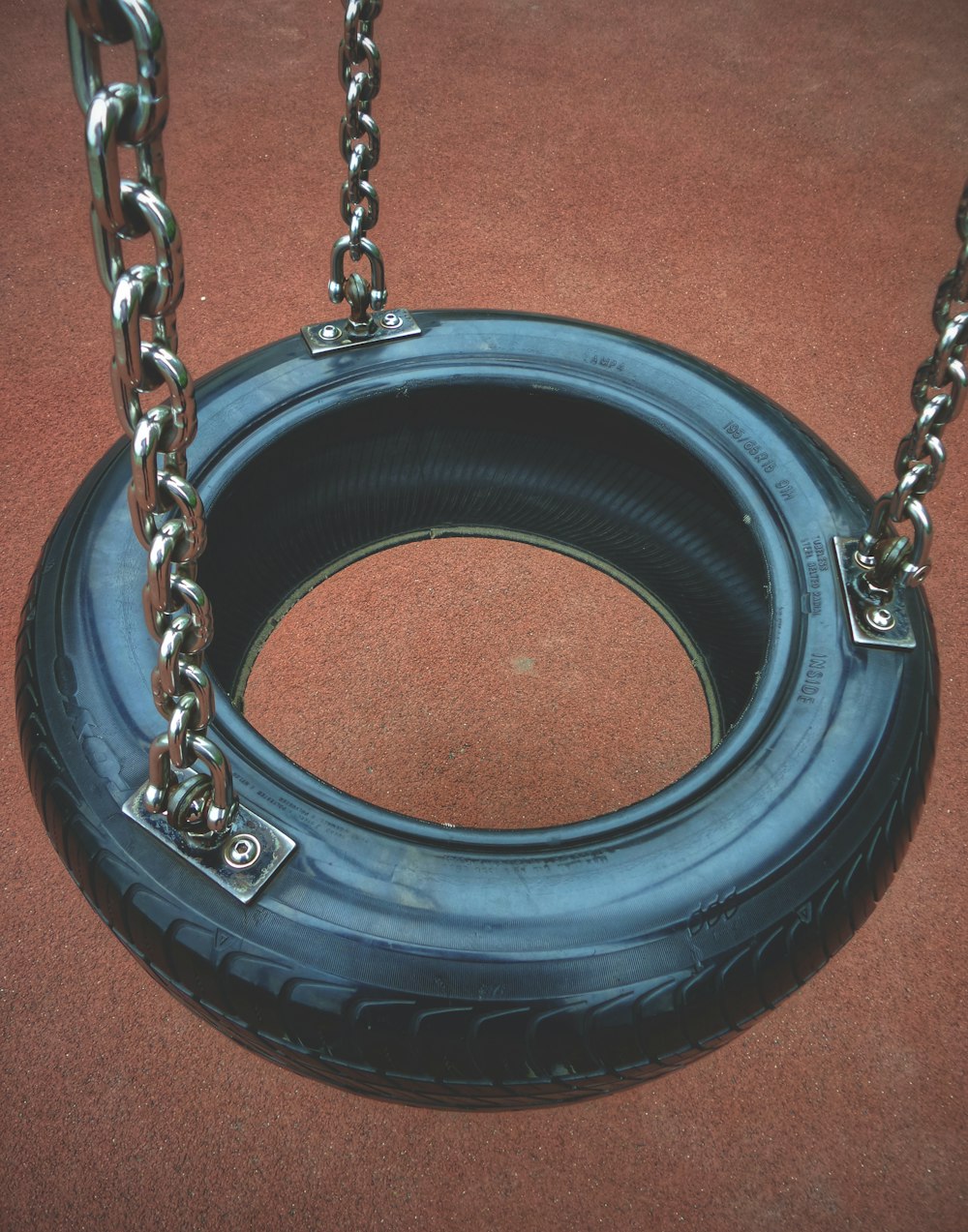 black tire swing on brown floor