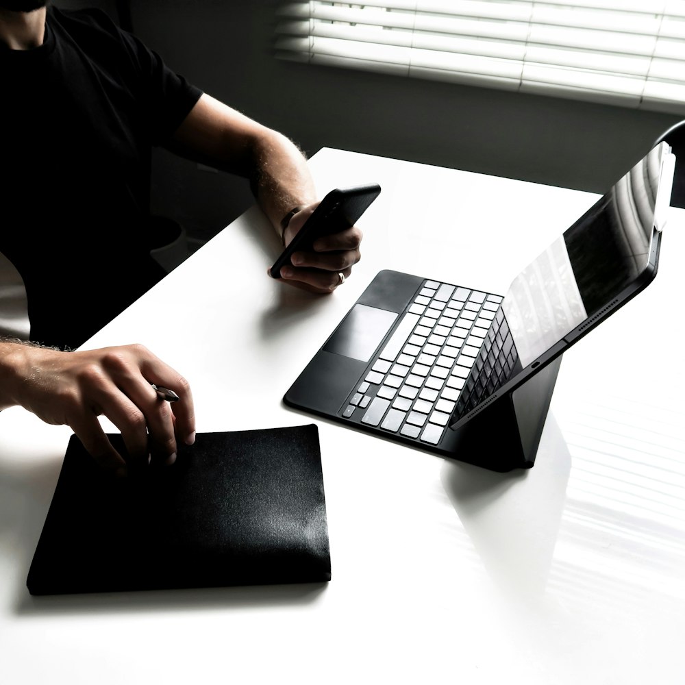 person using black and silver laptop computer