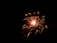 A vibrant burst of colorful fireworks exploding over a dark evening sky.