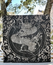 A detailed sketch of a majestic dragon entwined around a historic tall ship mast.