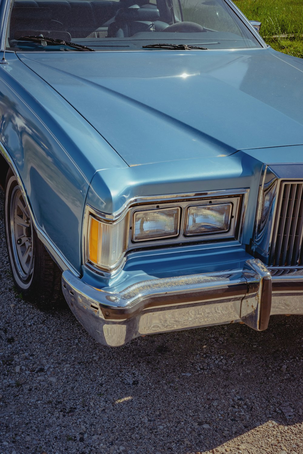 blue car on black asphalt road during daytime