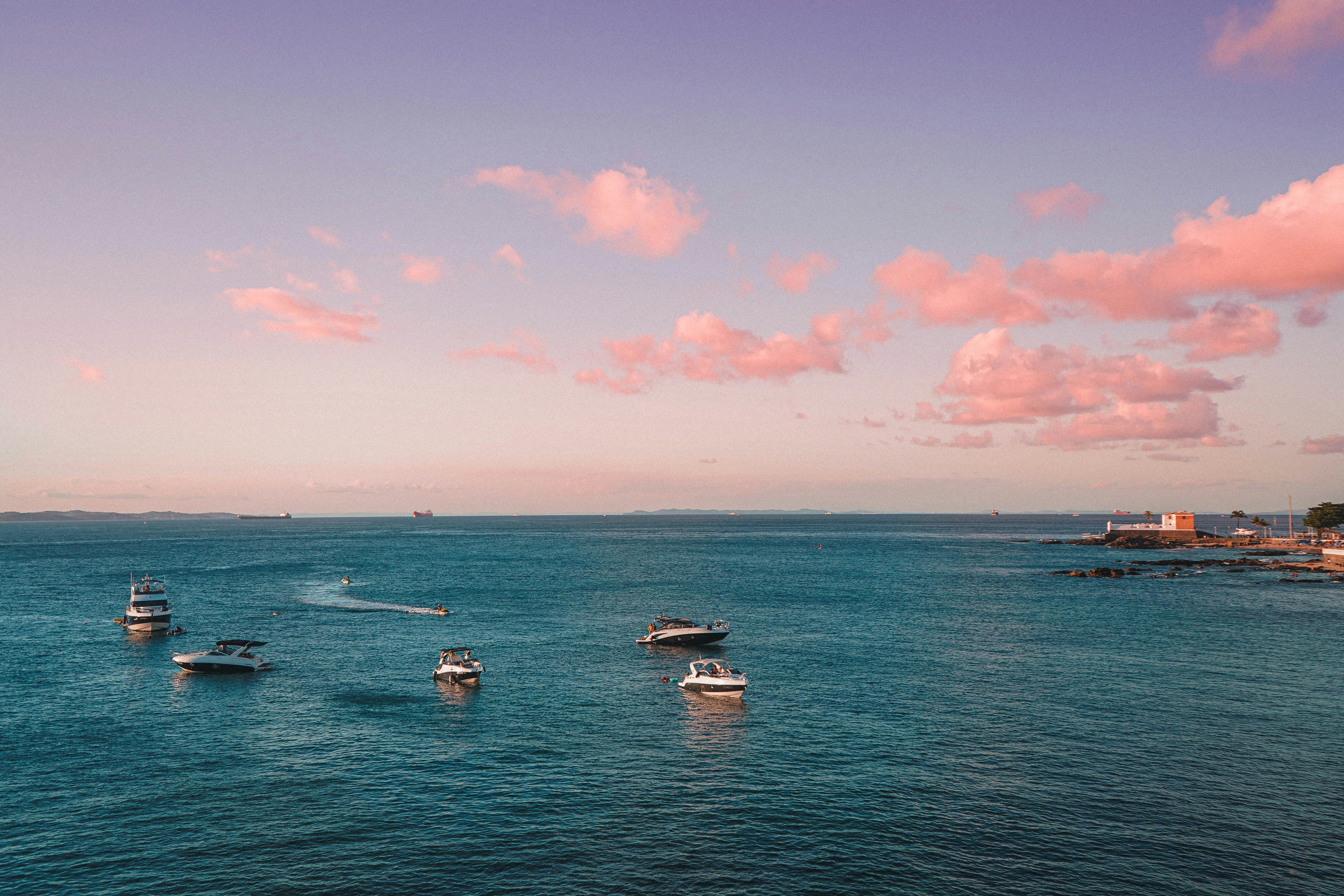 white boat on sea under blue sky during daytime