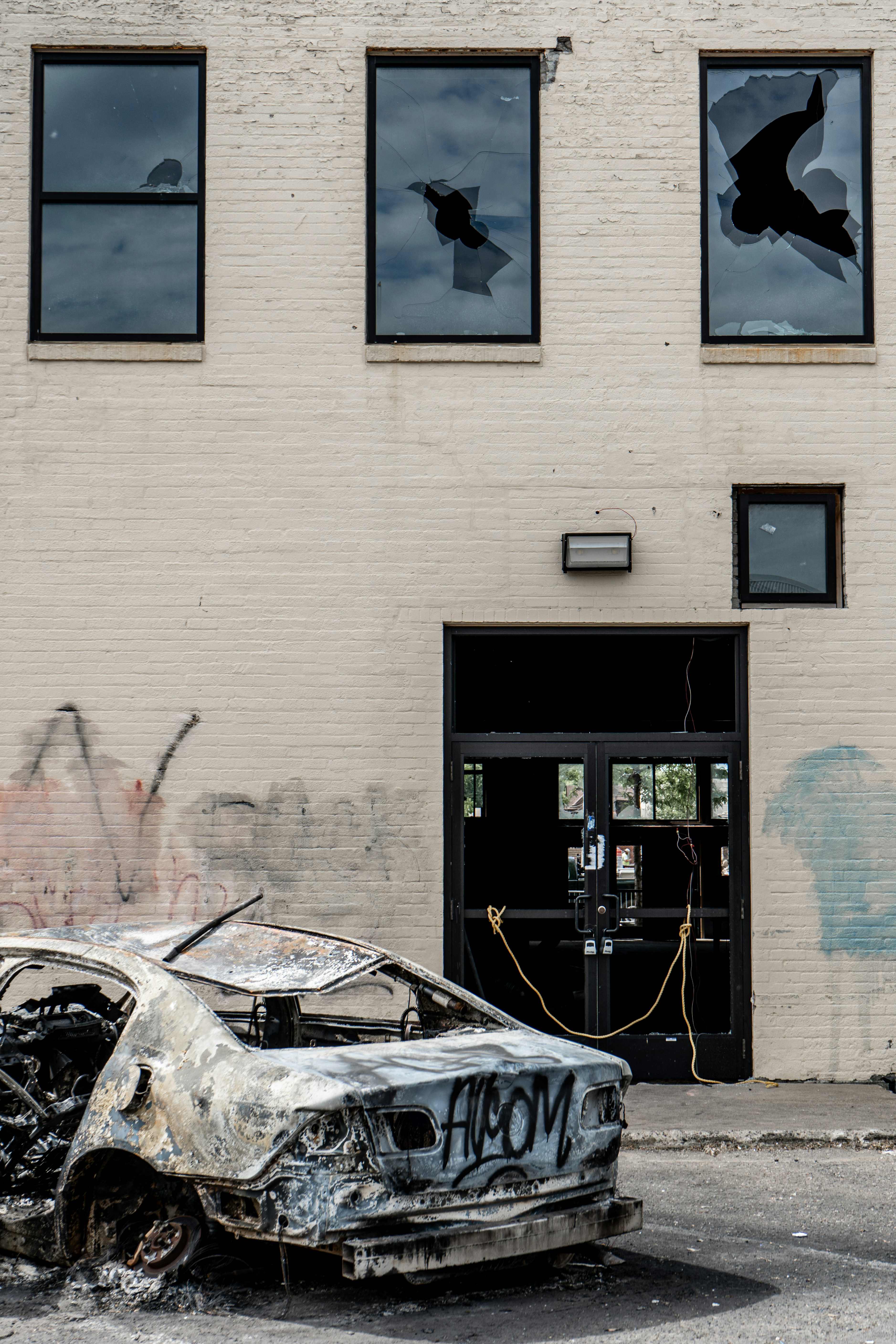 black car parked in front of brown building