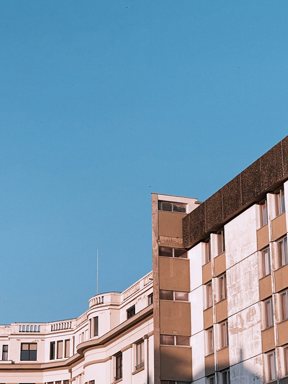 brown concrete building under blue sky during daytime