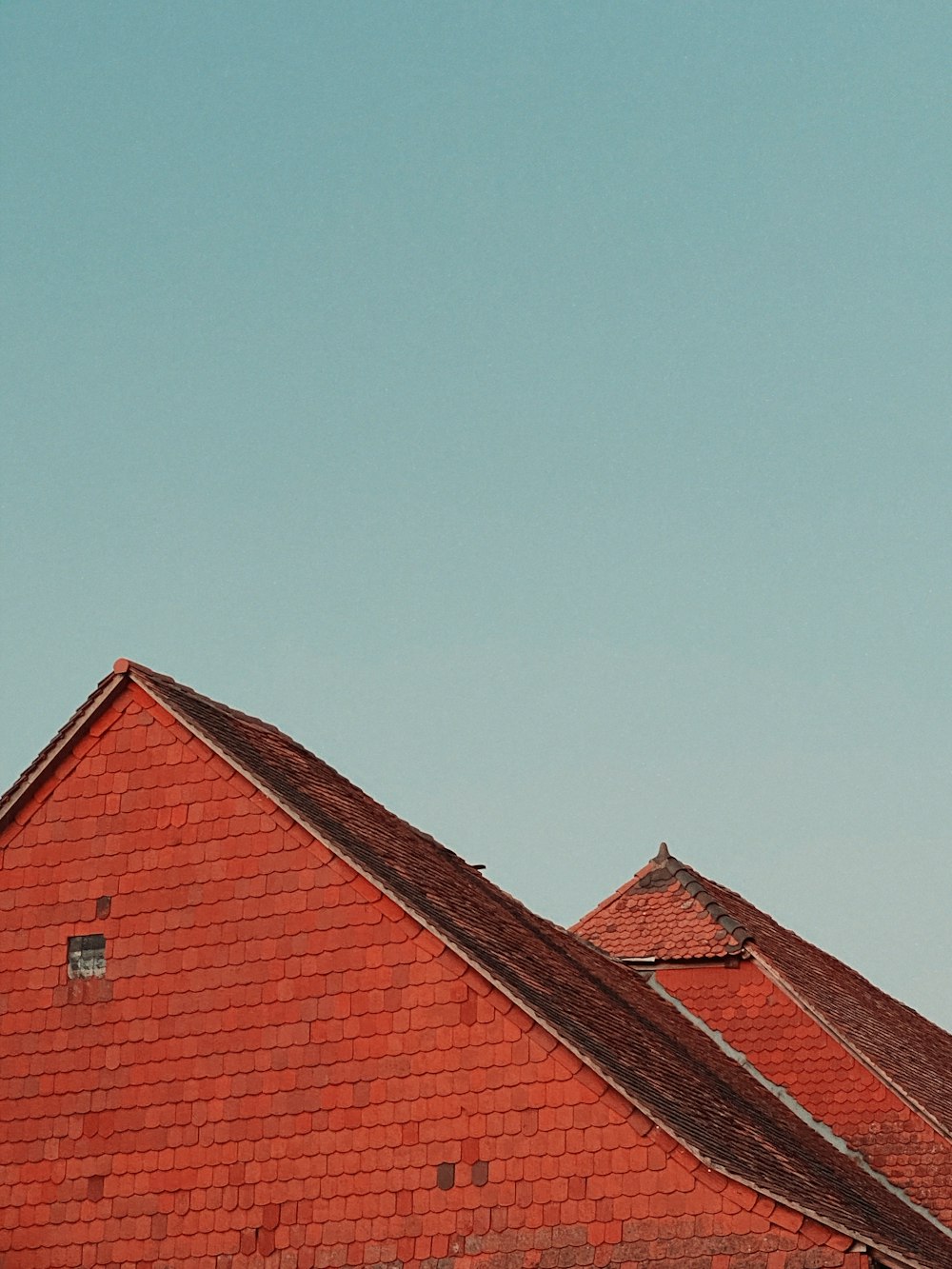 brown brick house under blue sky