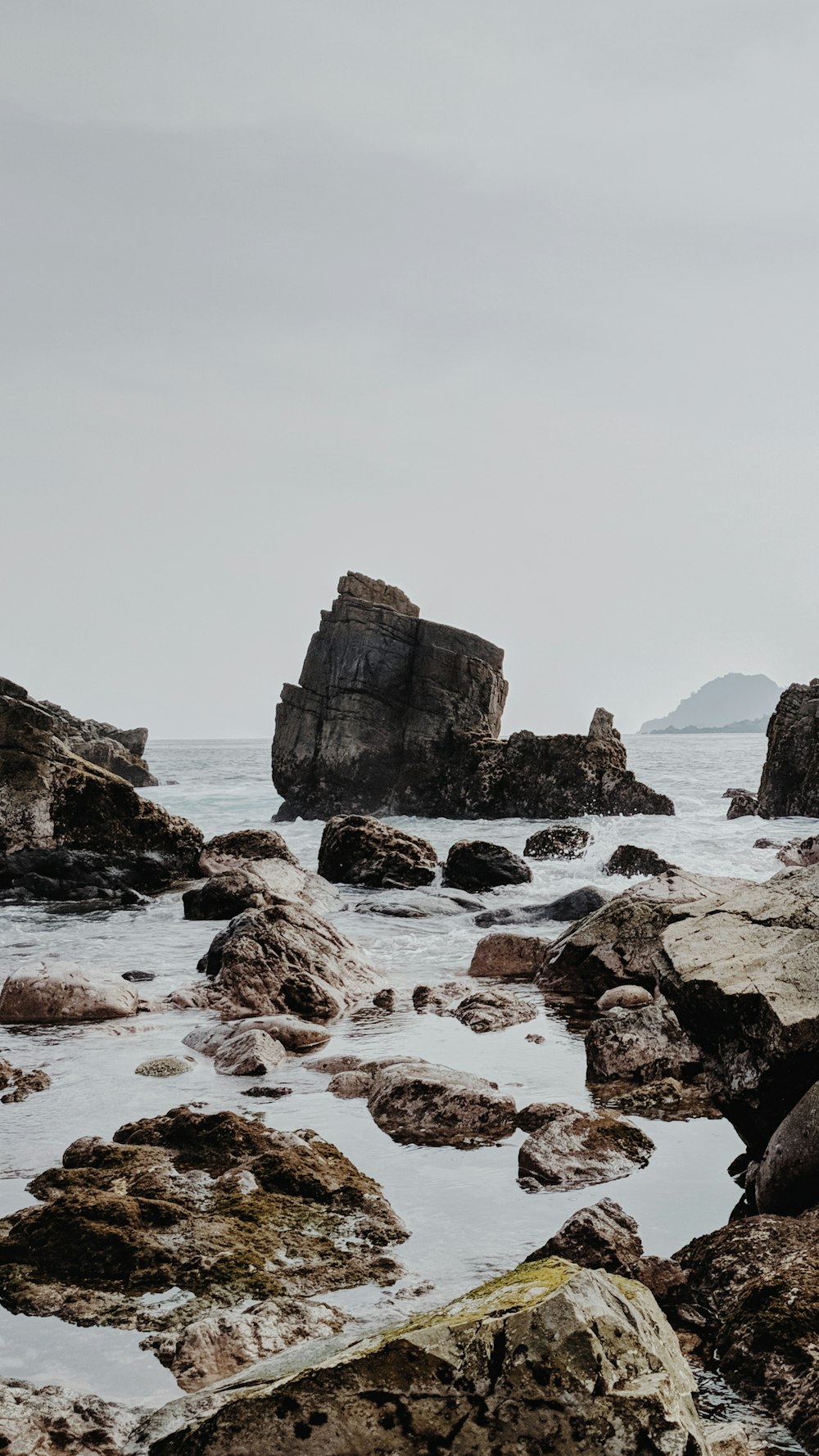 brown rock formation on sea during daytime