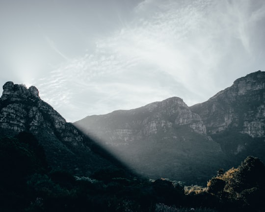 green mountains under white clouds during daytime in Kirstenbosch National Botanical Garden South Africa