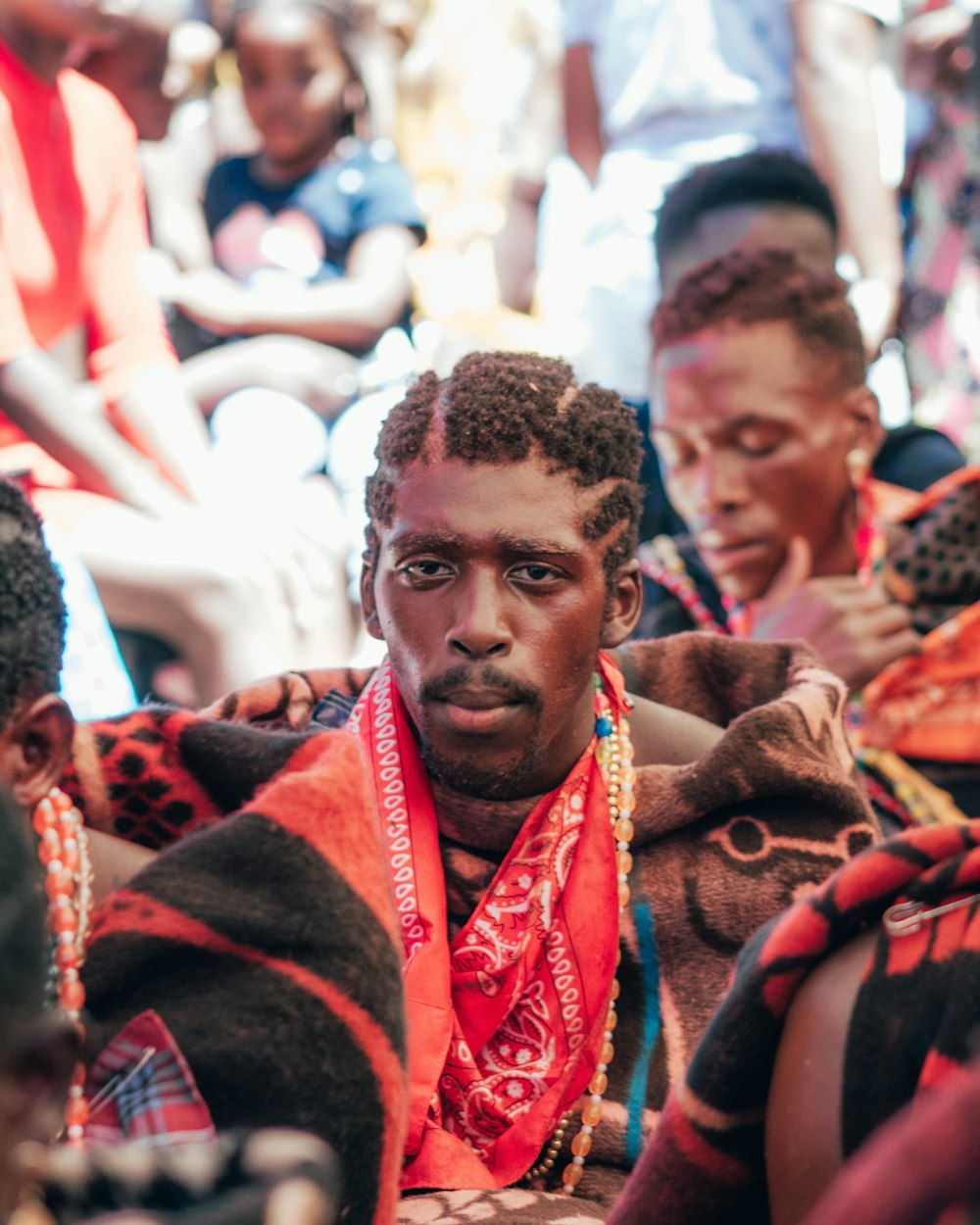 man in red and brown scarf