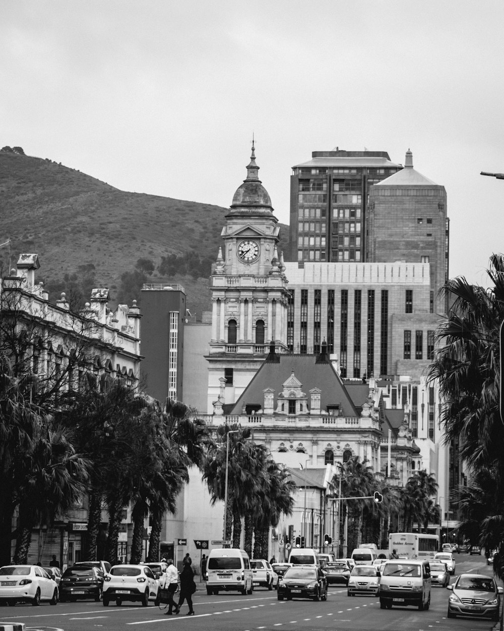 grayscale photo of building near mountain