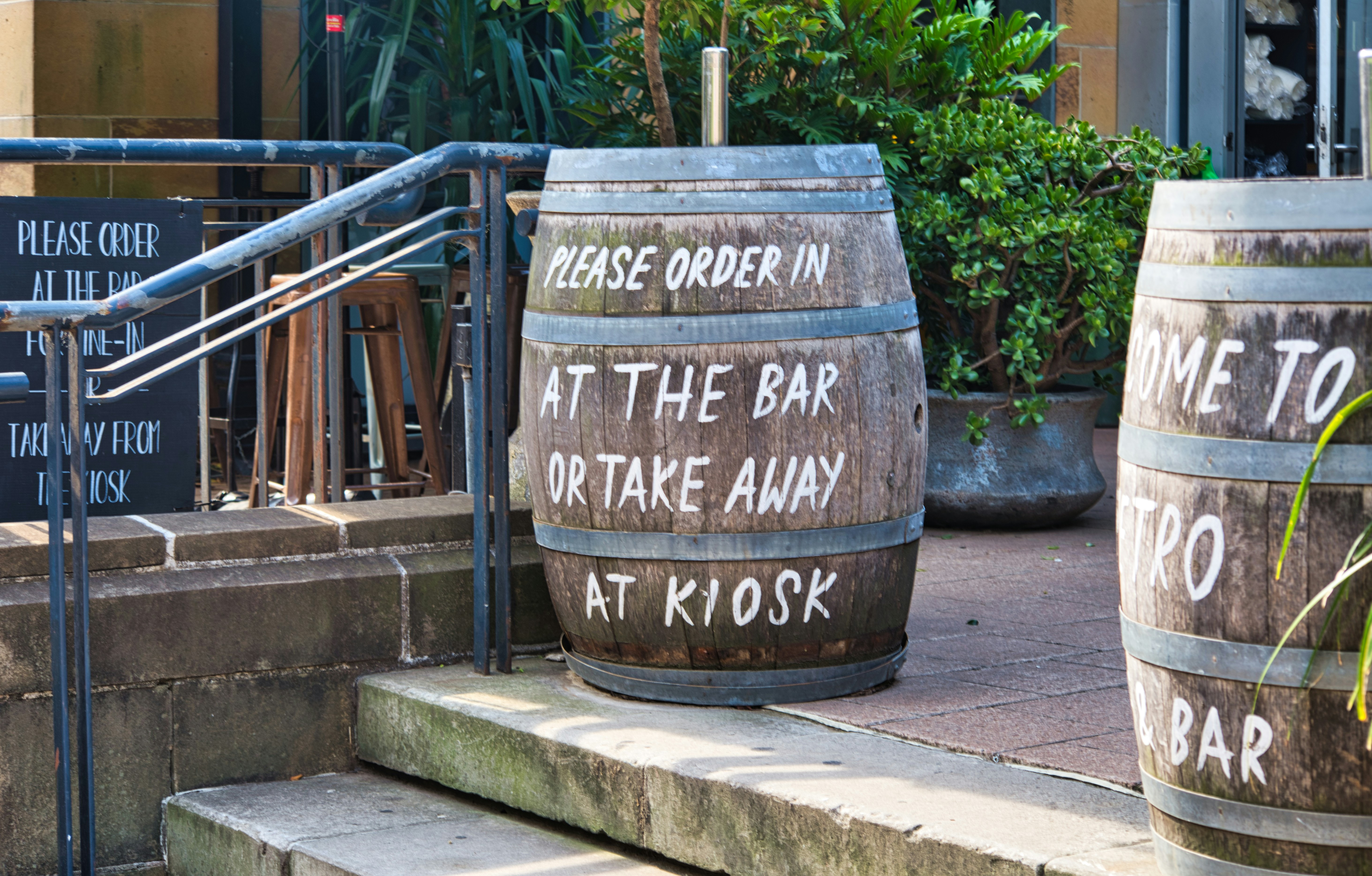 Barrels reading 'Please order at the bar'