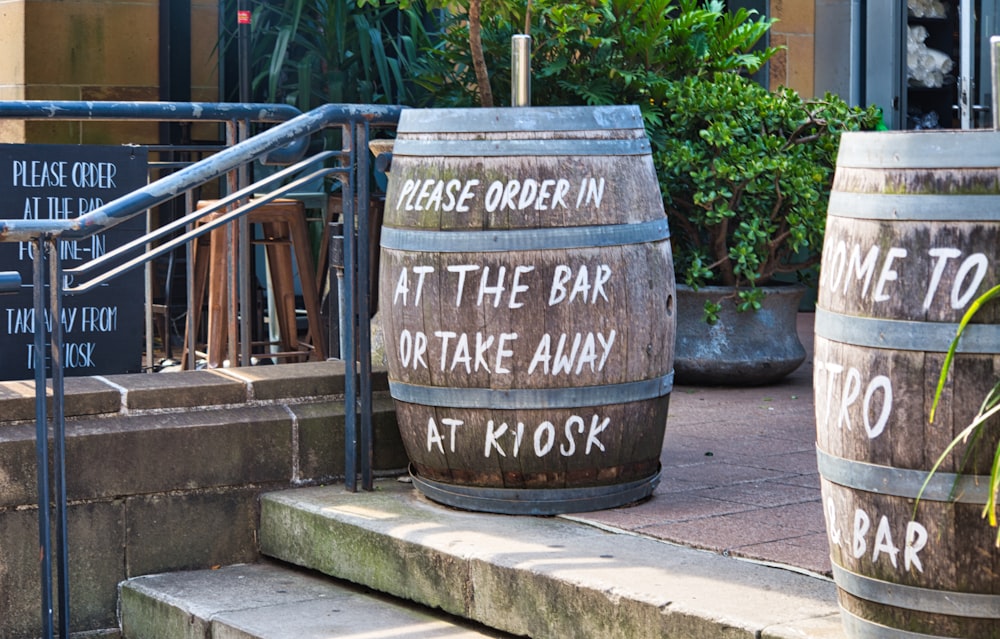 brown wooden barrel near green plants