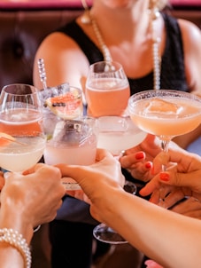 woman in black tank top holding clear wine glass