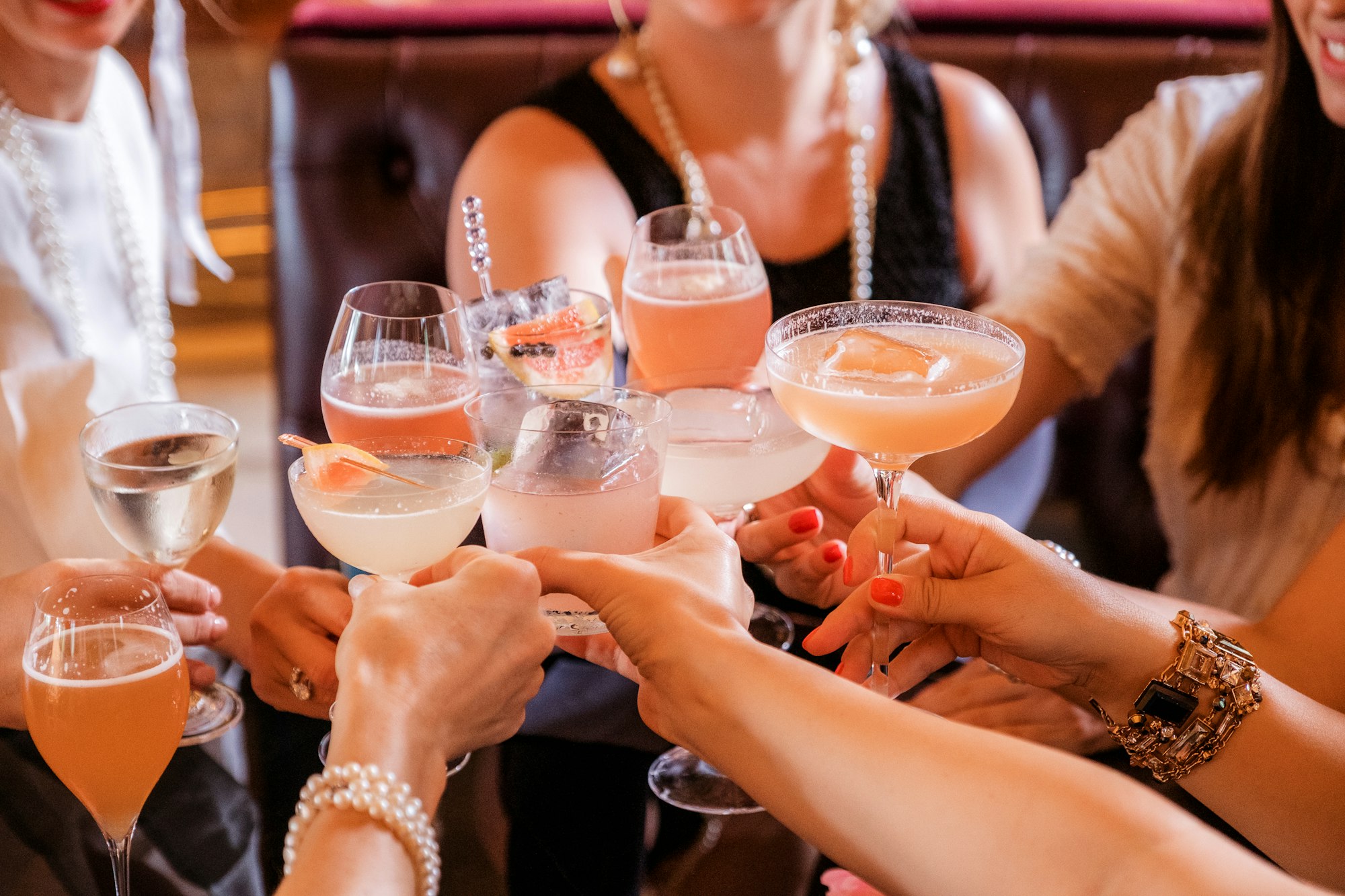 Girls cheersing with cocktails at a party