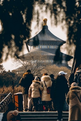 Students exploring a historic city landmark during a winter study tour, bundled up in warm clothes.