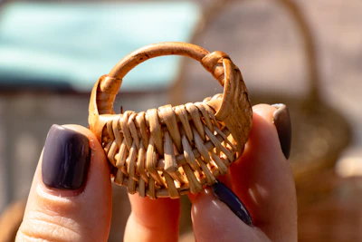 person holding brown wooden ring