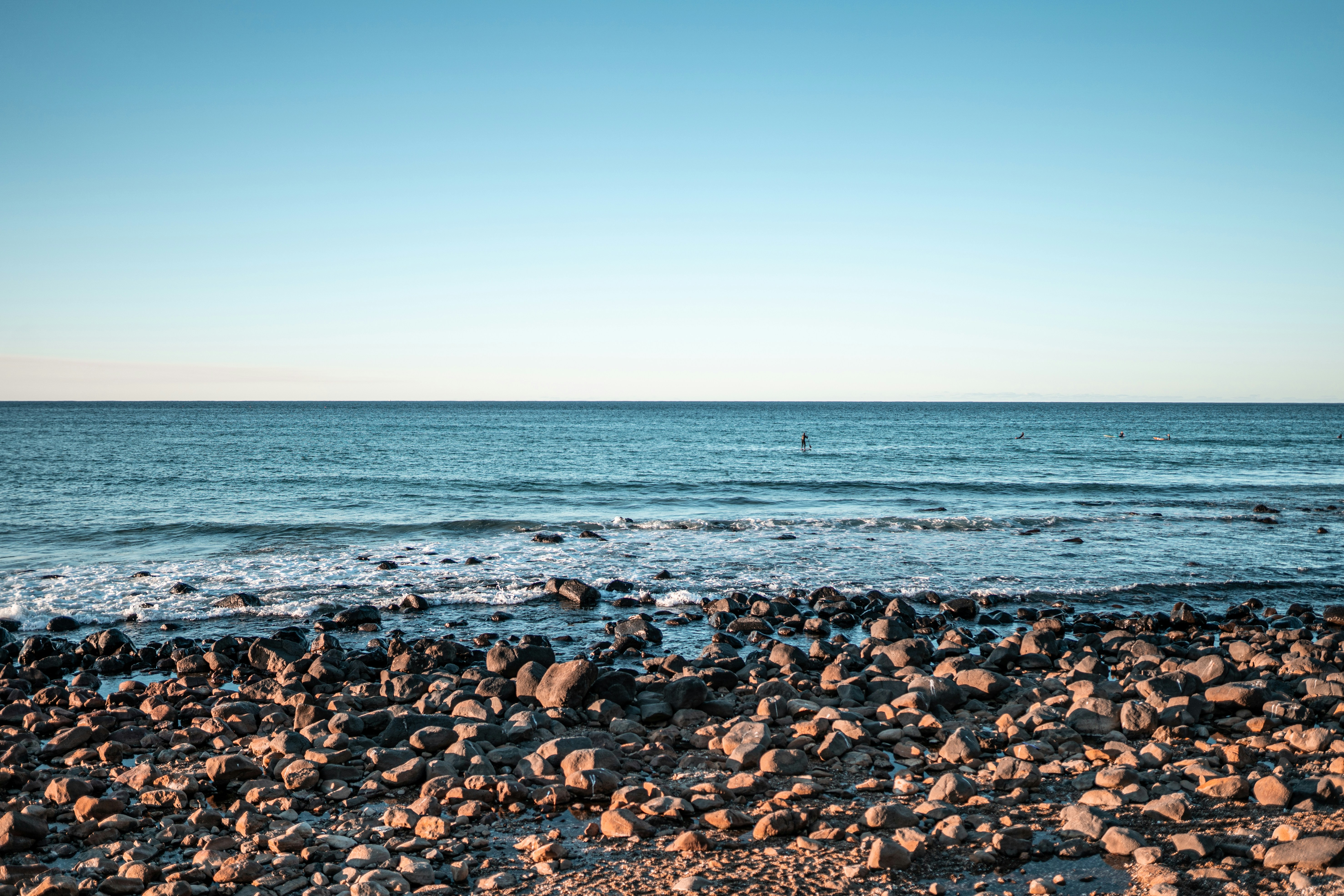 brown and black stones on beach during daytime