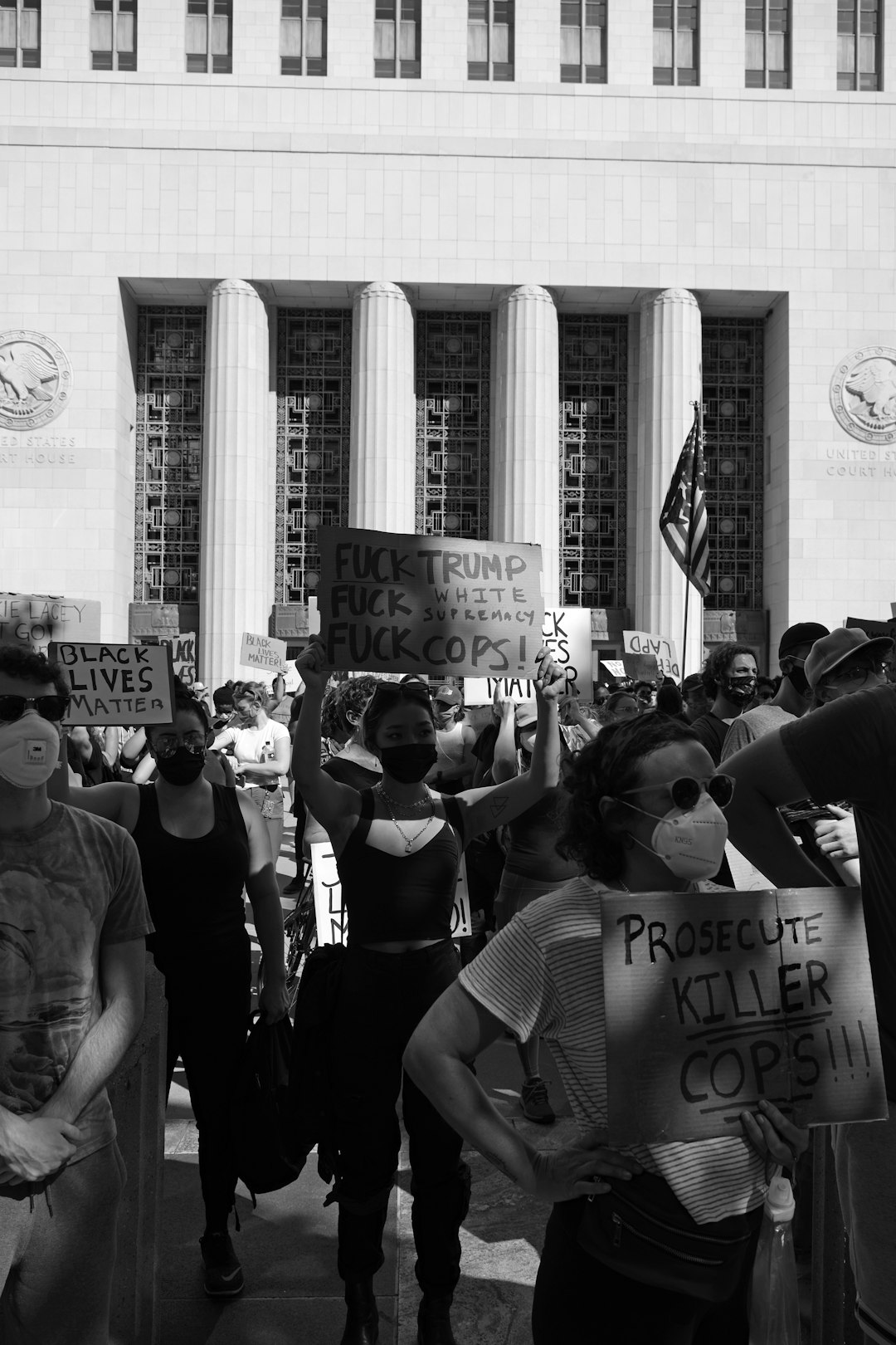 grayscale photo of people in a city