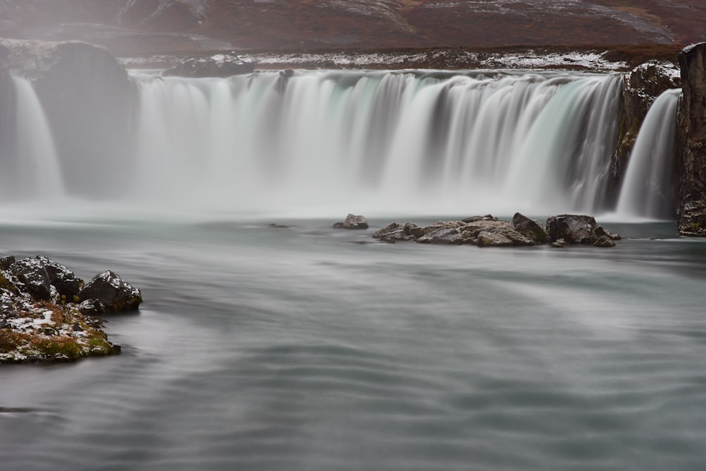 black boat on water falls