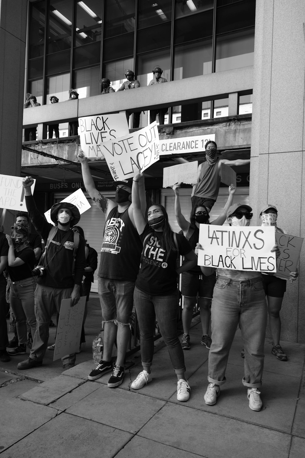 a group of people holding signs on a sidewalk