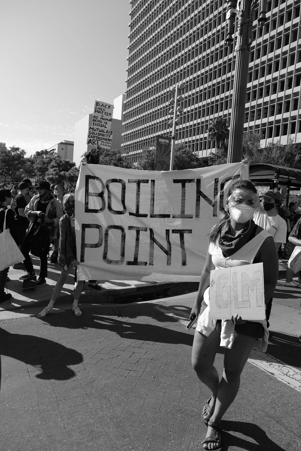 grayscale photo of woman holding white and black banner