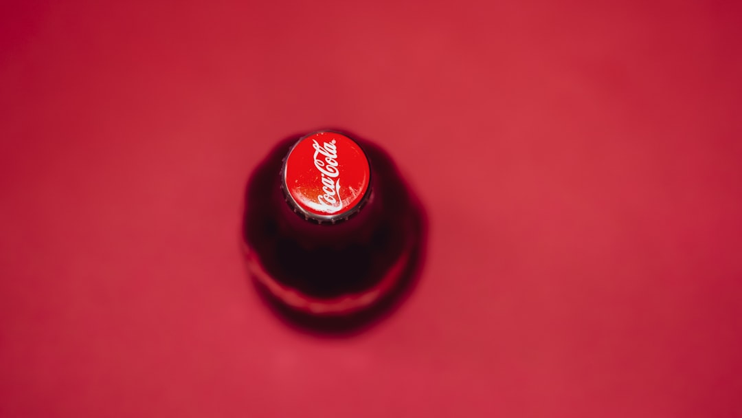 coca cola bottle cap on red surface
