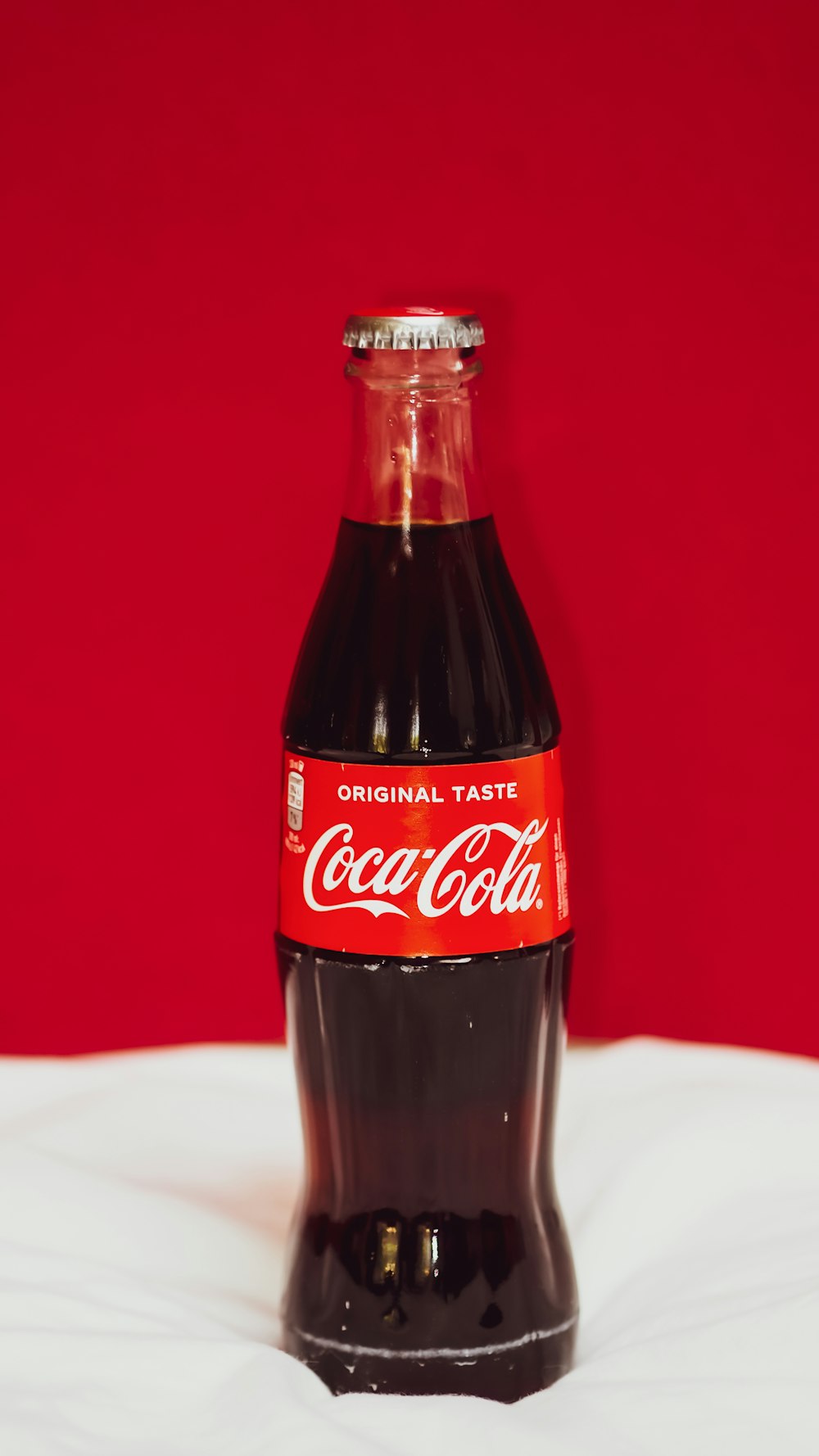 coca cola bottle on white table