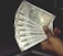 A hand holding multiple Indian 500 rupee banknotes, fanned out. The banknotes feature a portrait of Mahatma Gandhi and are from the Reserve Bank of India.