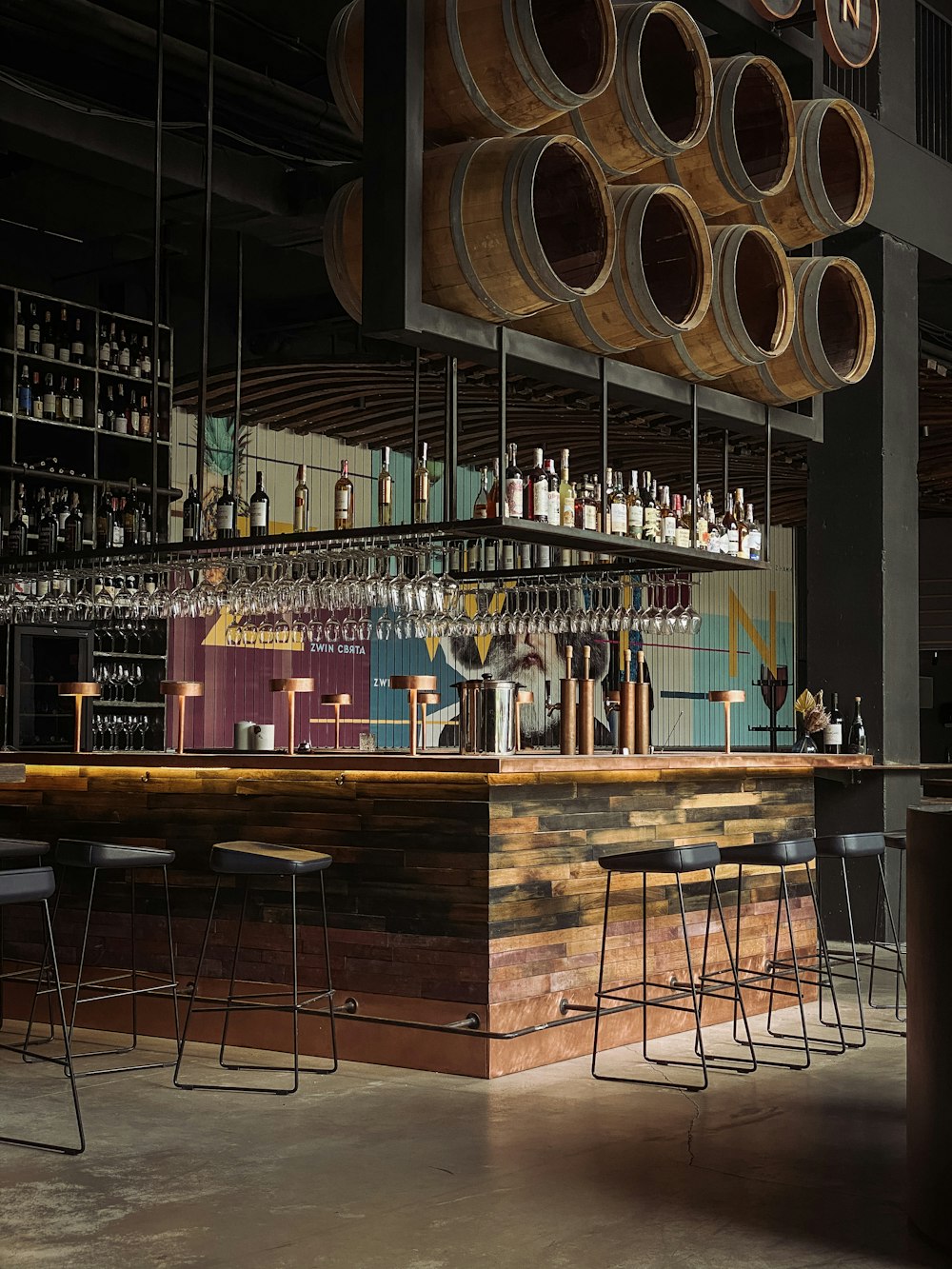 brown wooden bar counter with wine bottles