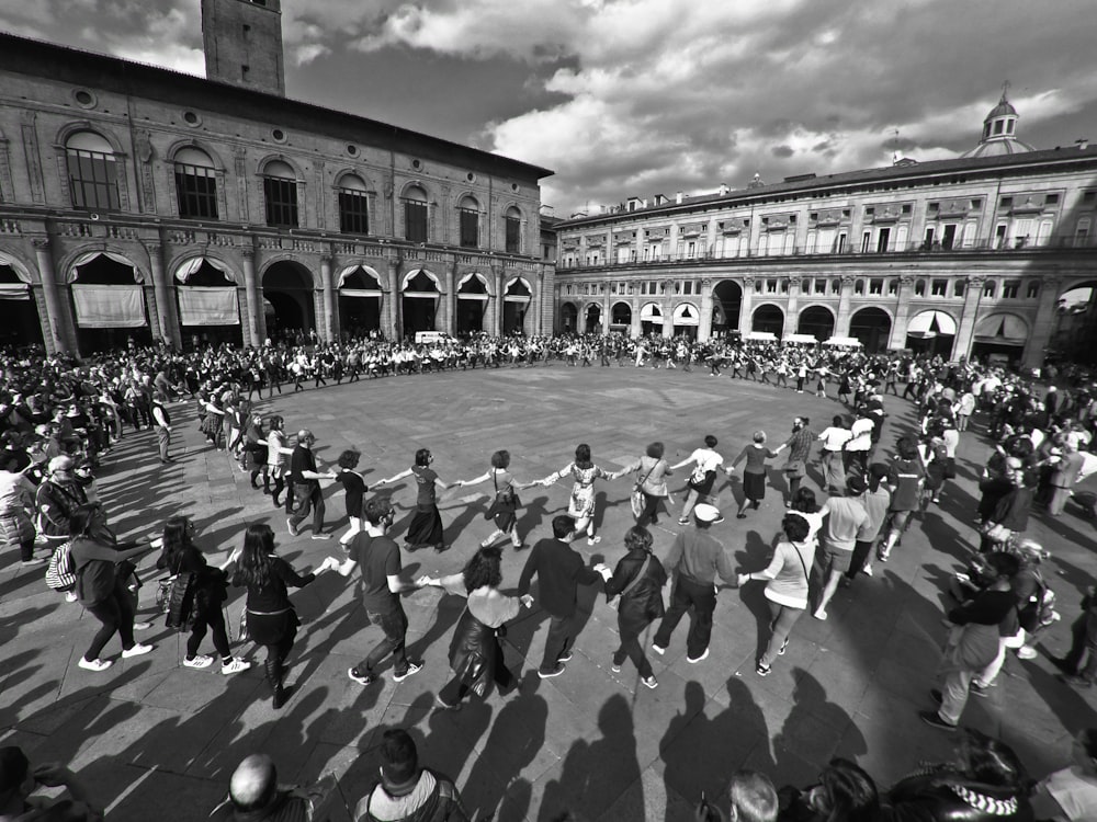 people walking on street in grayscale photography