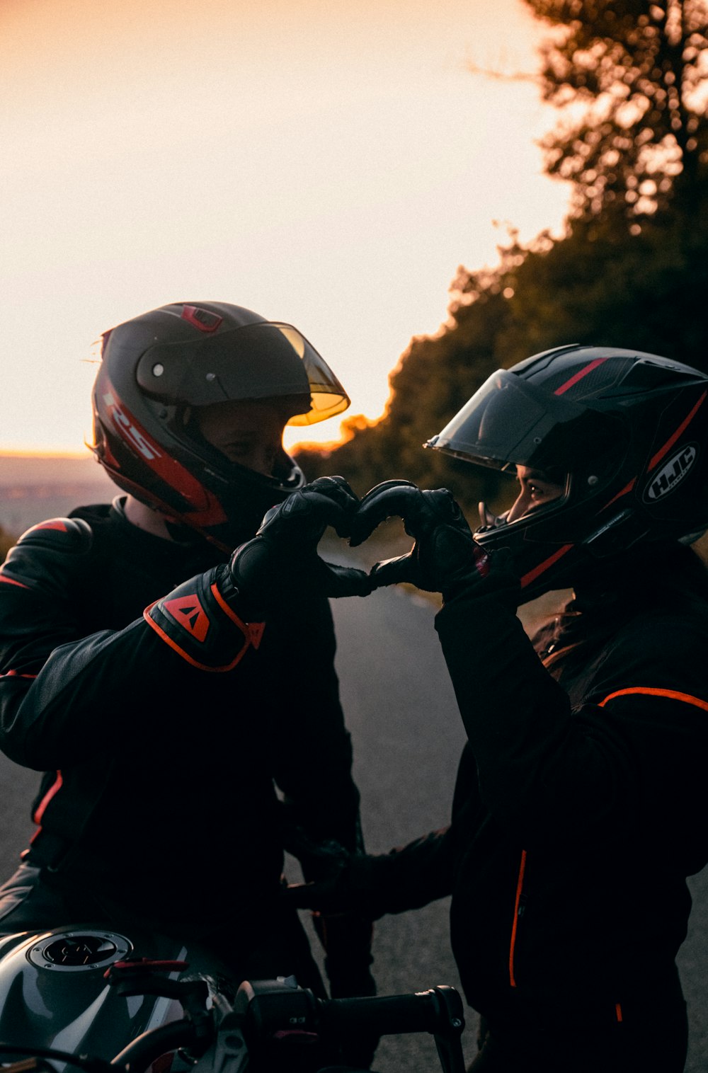 2 men in black jacket wearing helmet during daytime