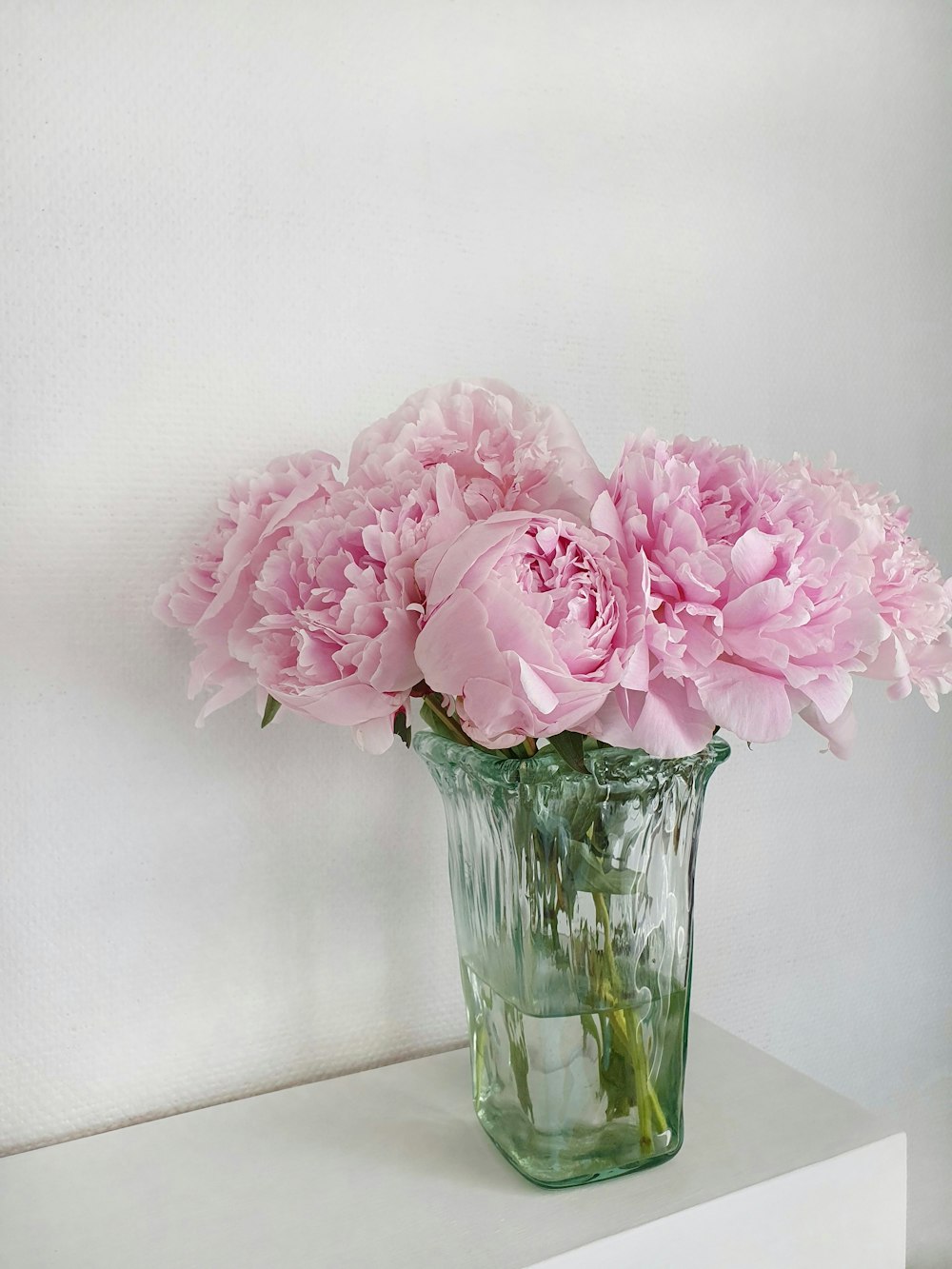 pink flowers in clear glass vase