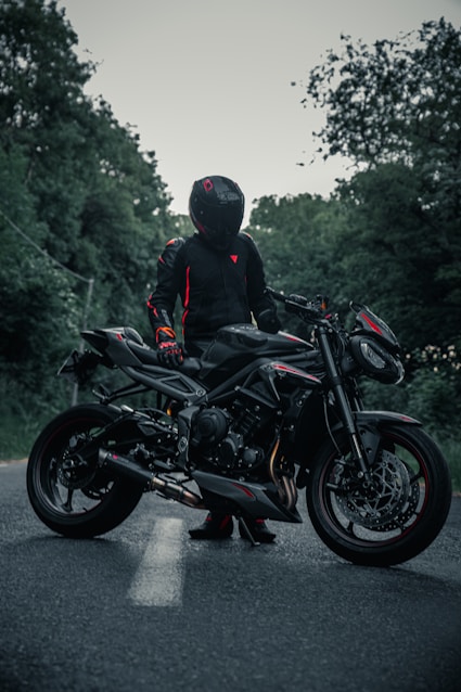 man in black jacket riding black motorcycle