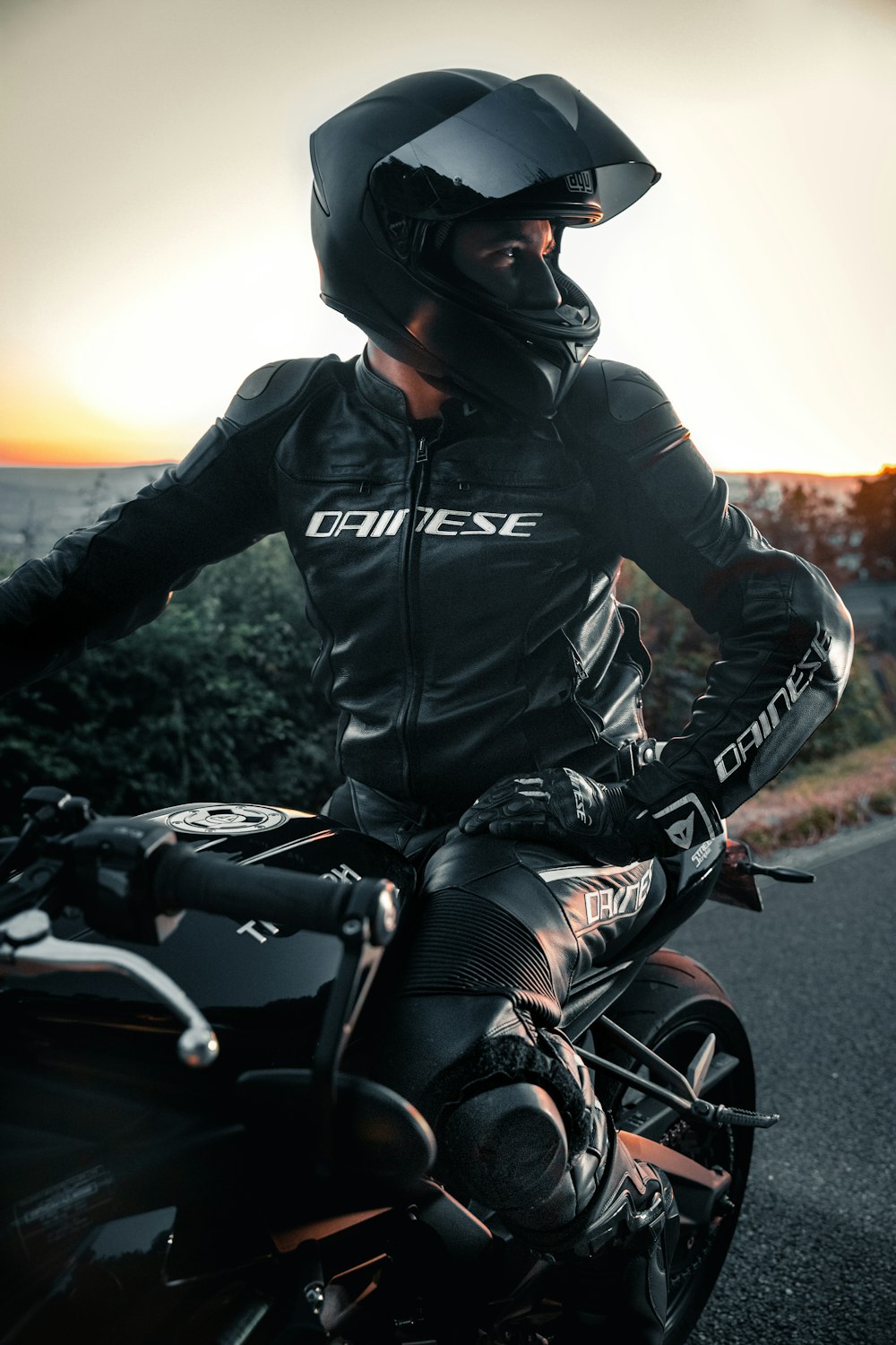 Mann in schwarzer Lederjacke fährt tagsüber Motorrad