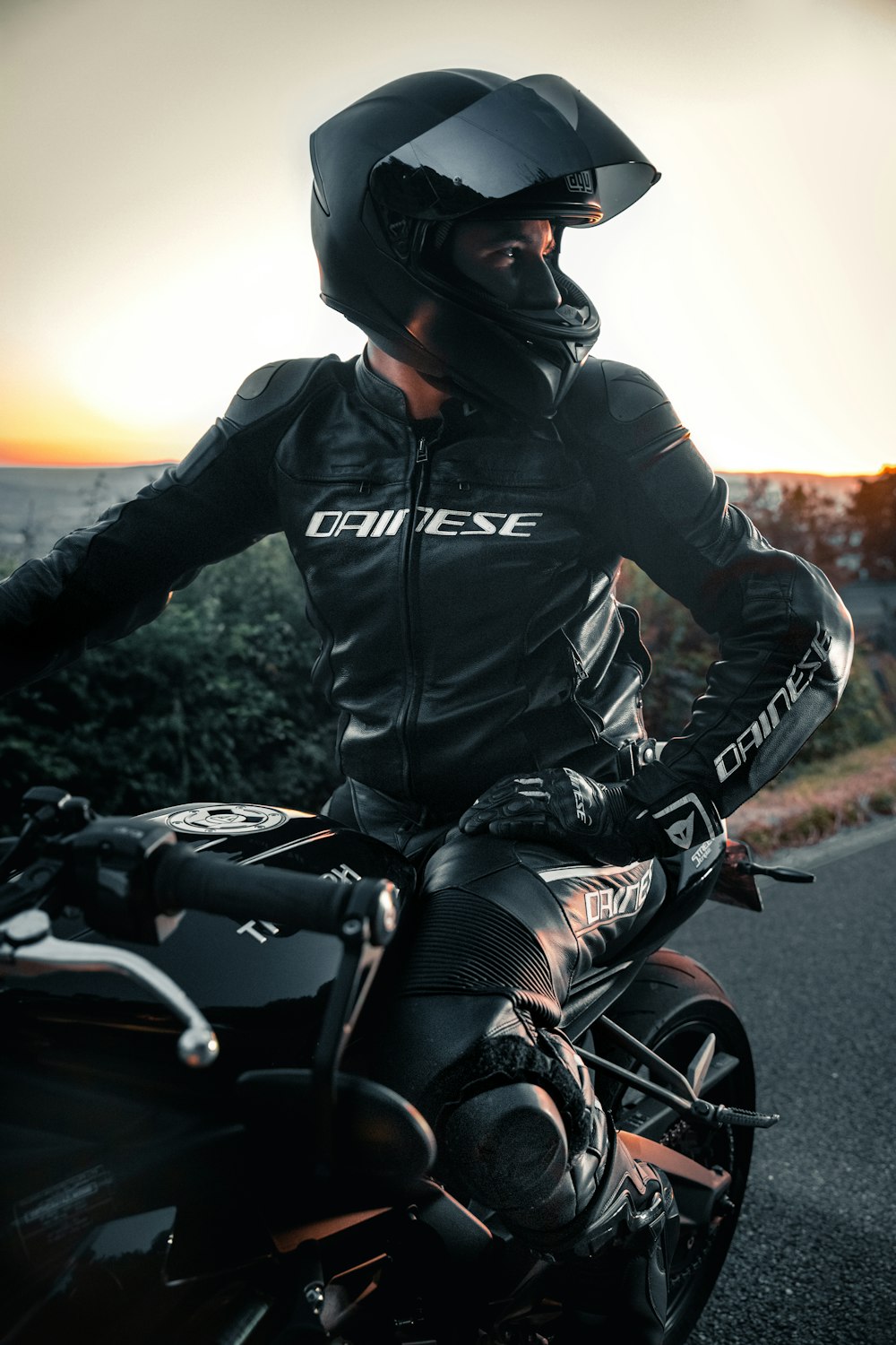 man in black leather jacket riding motorcycle during daytime