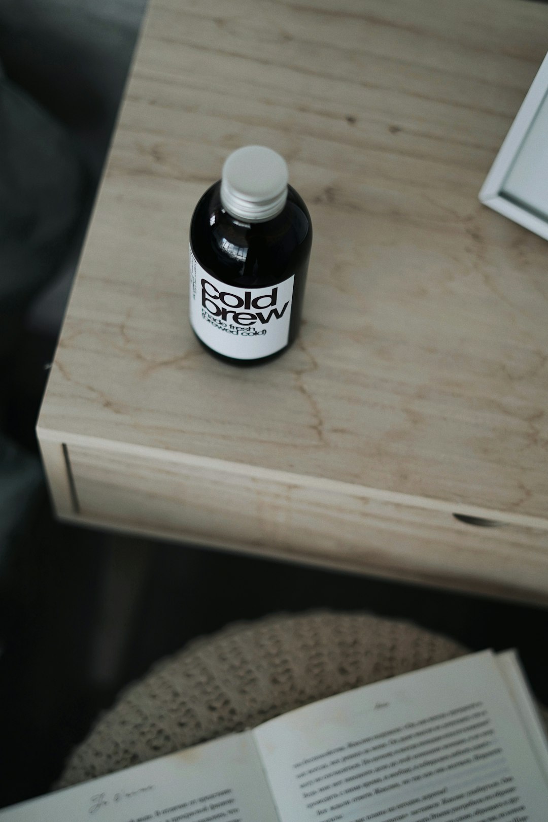 black and white labeled bottle on brown wooden table