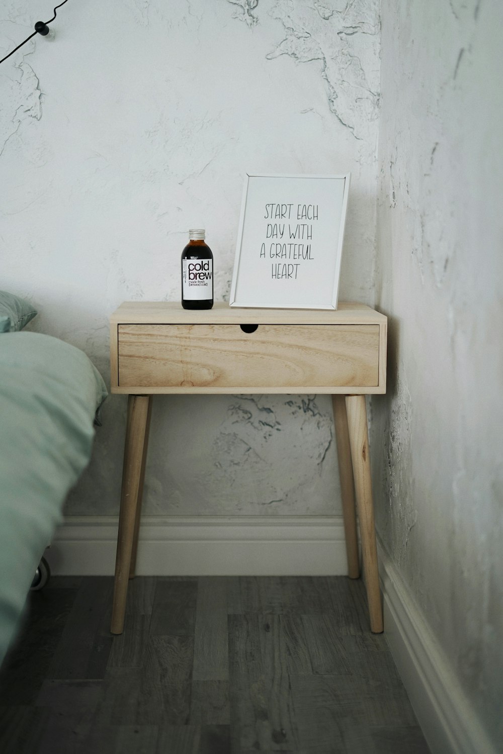 black glass bottle on brown wooden table