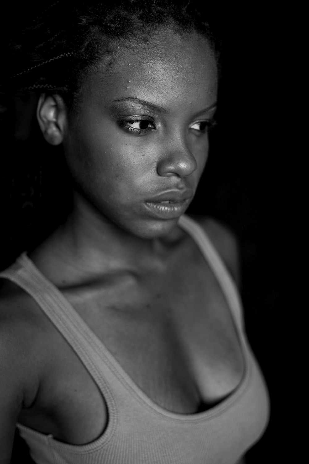 woman in tank top wearing black hat