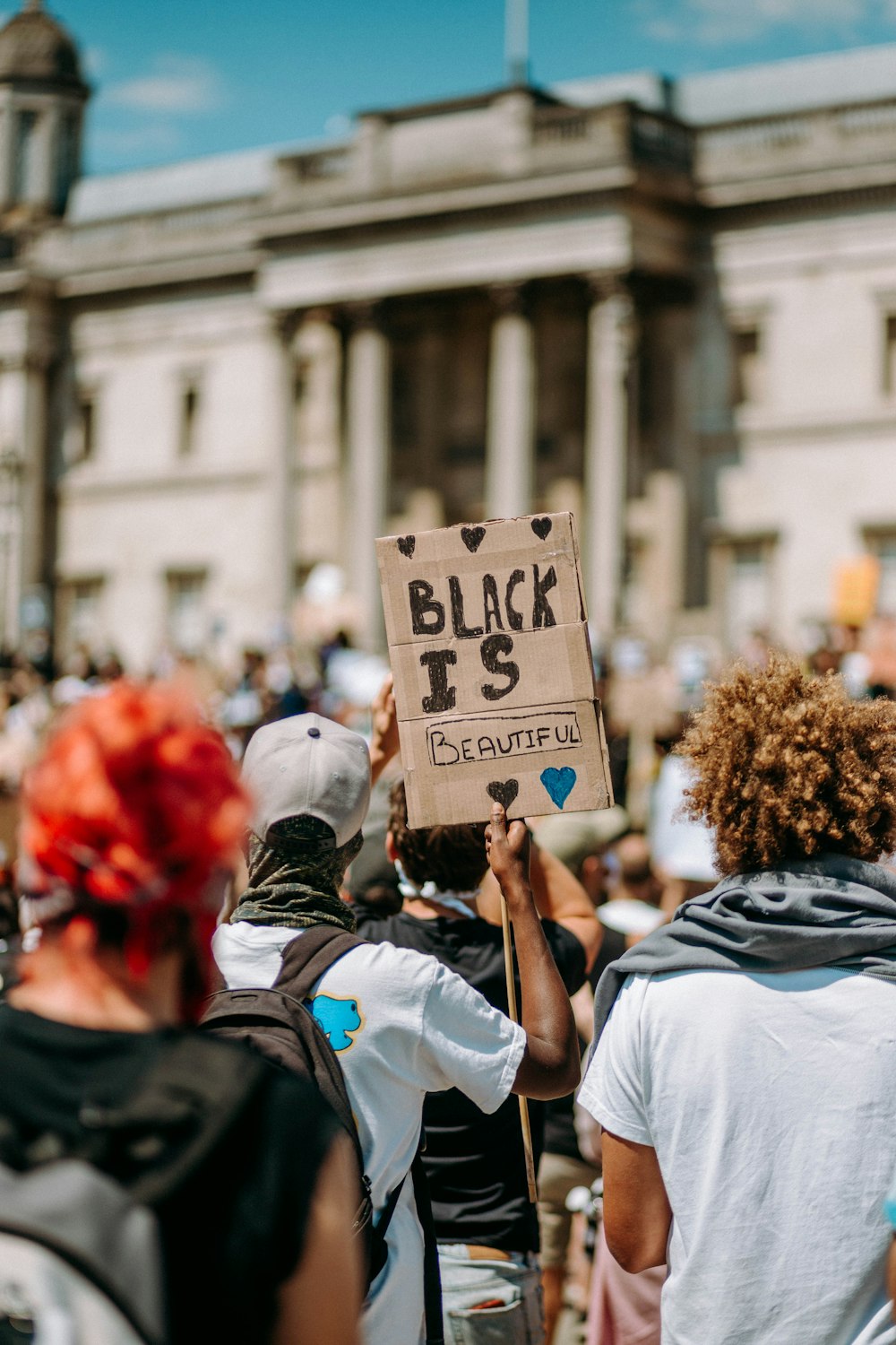 people in white shirts holding white and blue board during daytime