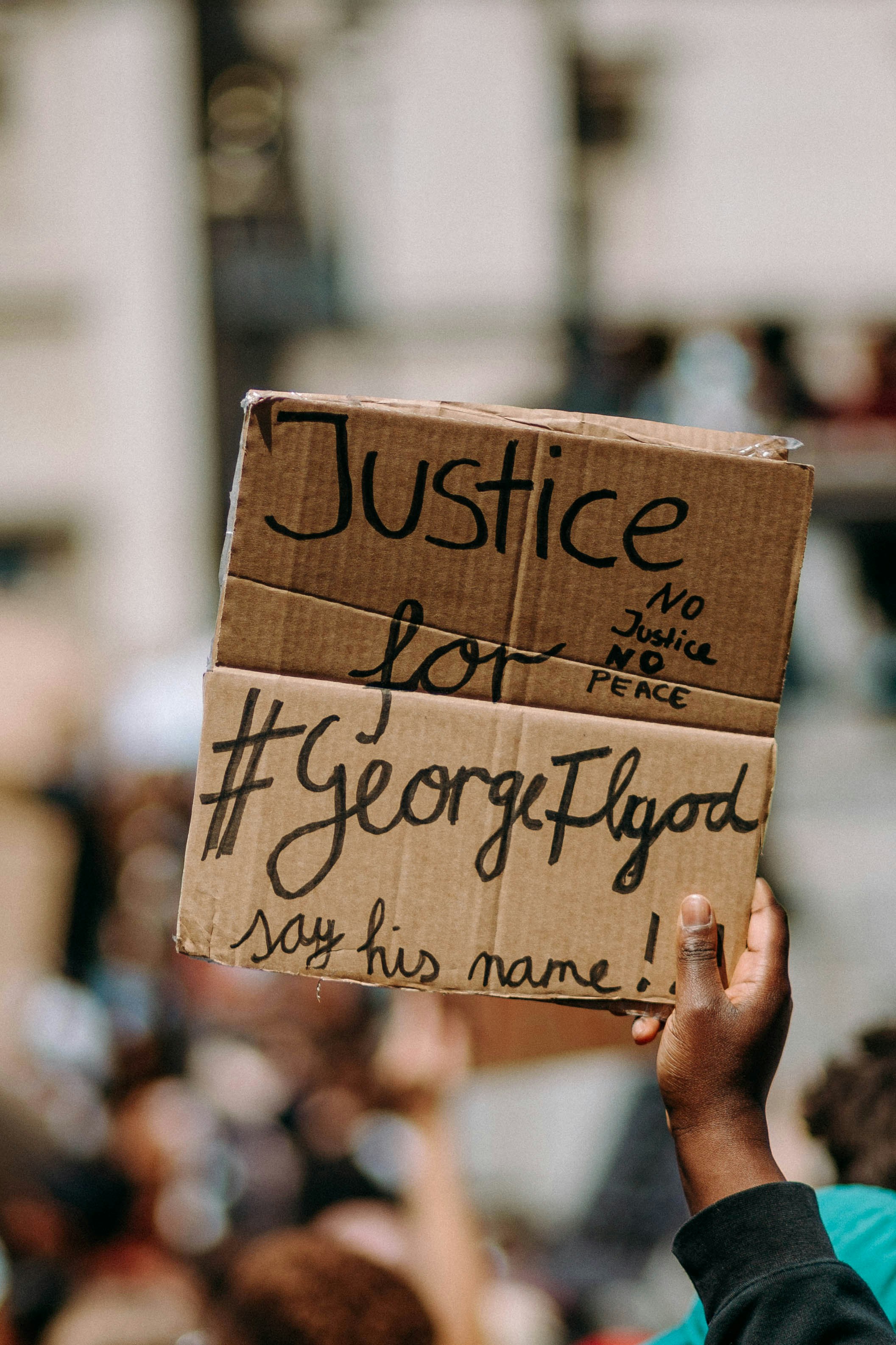 person holding brown wooden i love you print board