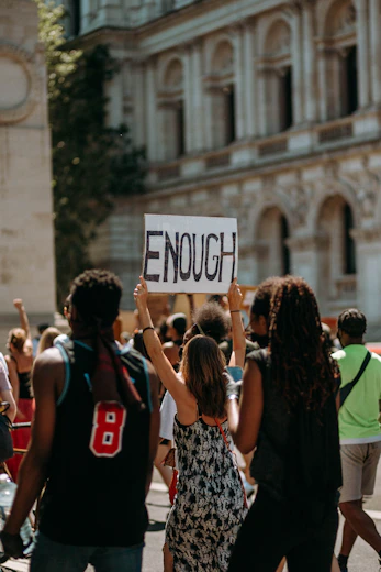 people holding a signage during daytime