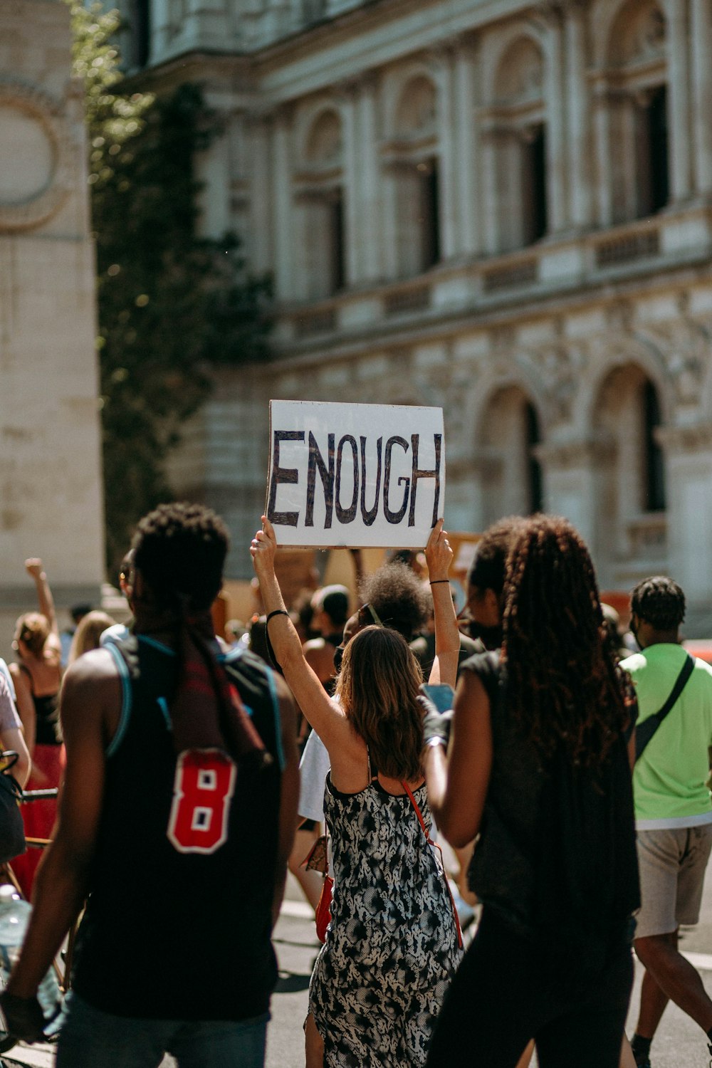 people holding a signage during daytime