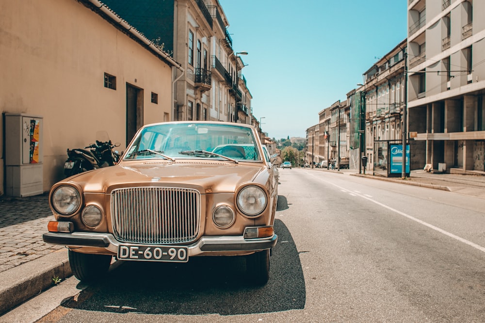 classic beige car parked on side of the road