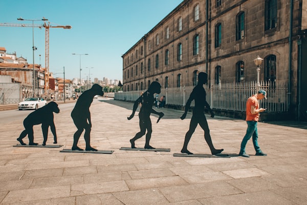 Evolution to man holding cell phone