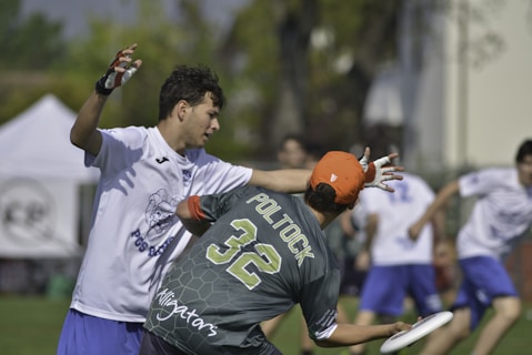 man in white and blue crew neck t-shirt wearing orange helmet