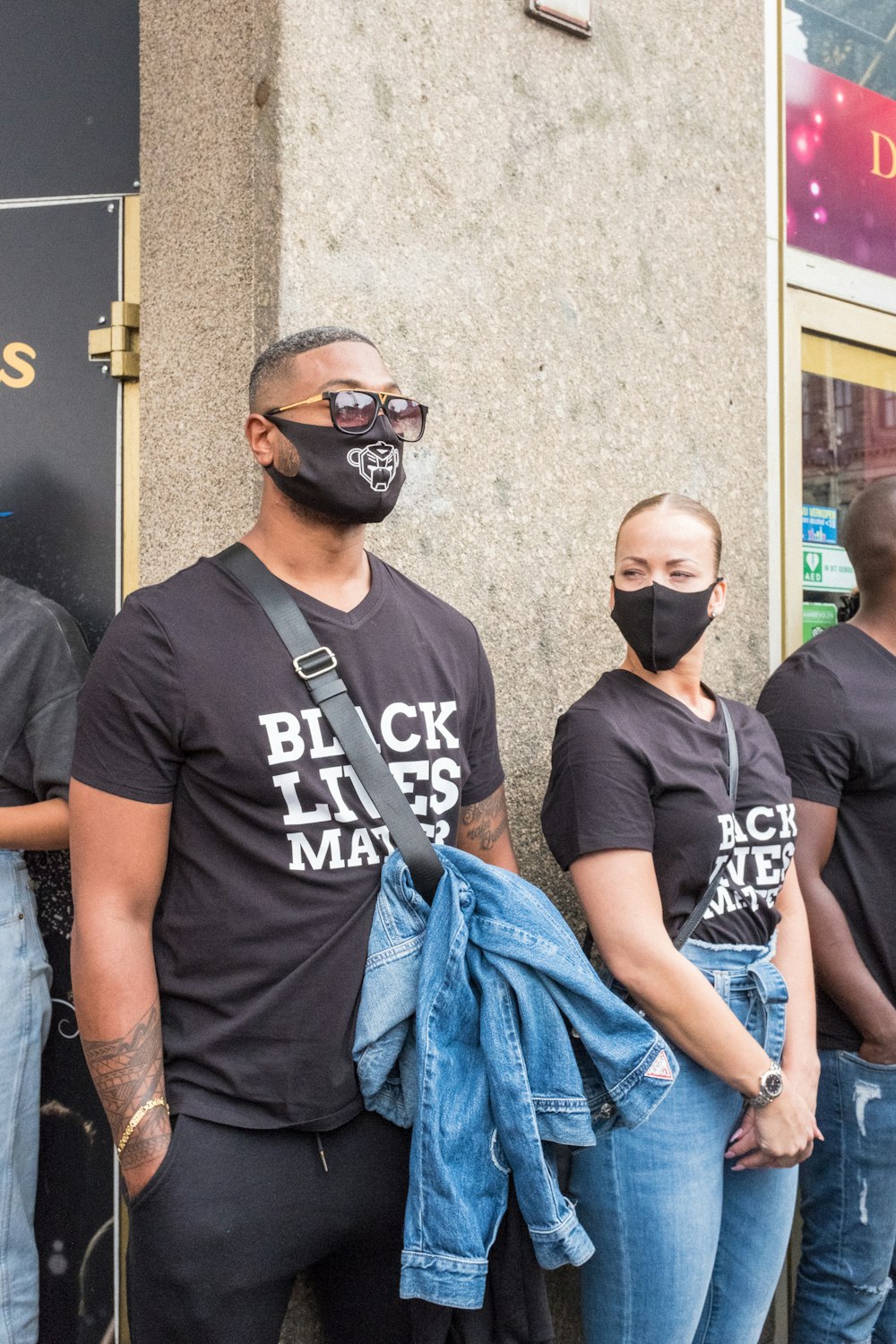 man in black crew neck t-shirt standing beside man in black crew neck t-shirt