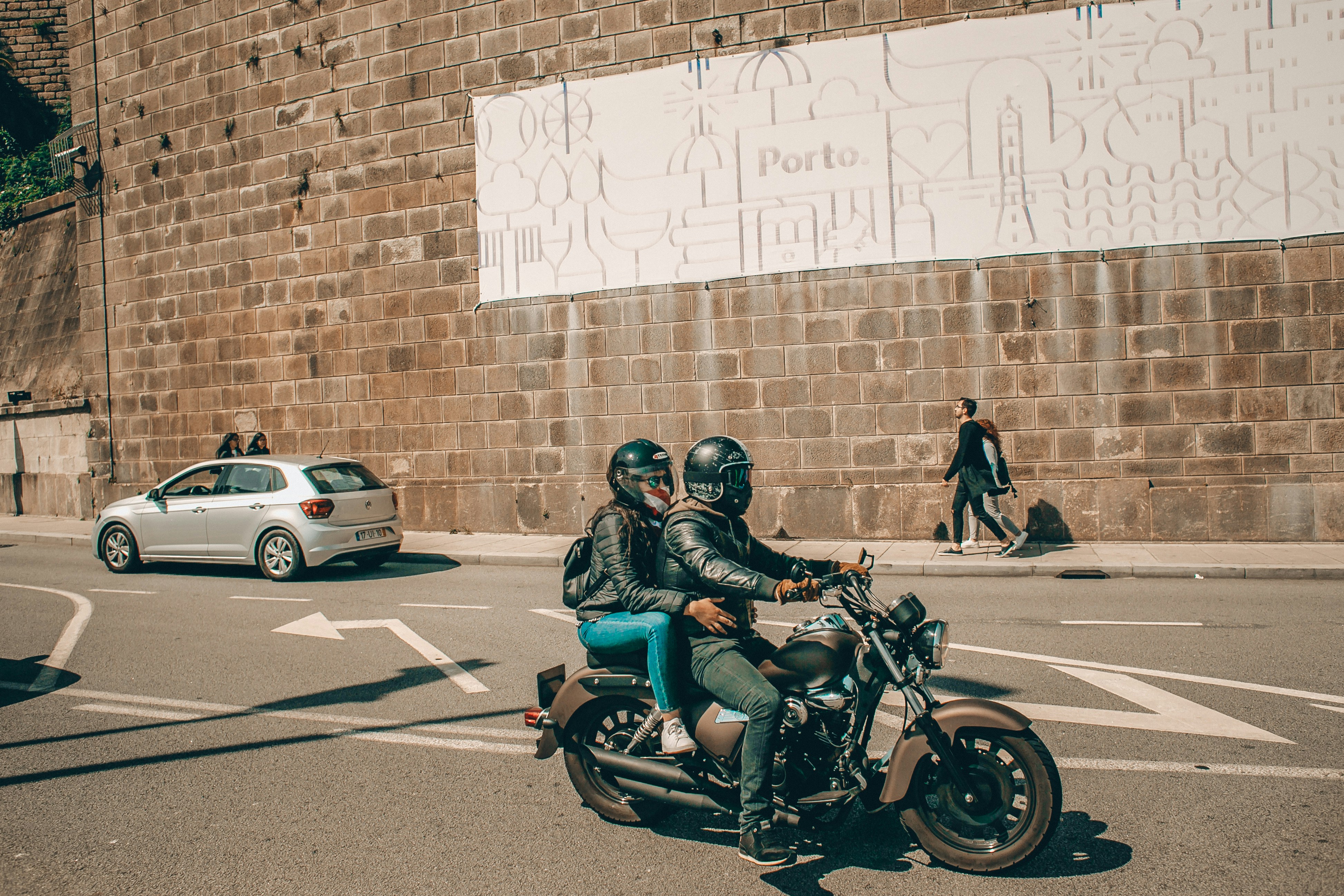 man in blue jacket riding on black motorcycle
