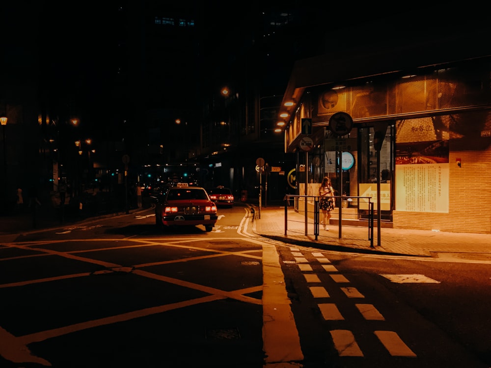 cars parked on sidewalk during night time