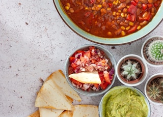 red and green chili peppers in white ceramic bowl